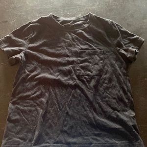Black t shirt with front pocket.